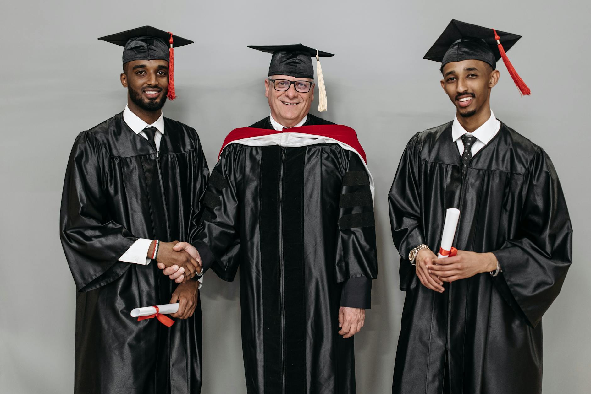 photo of men in black graduation gown